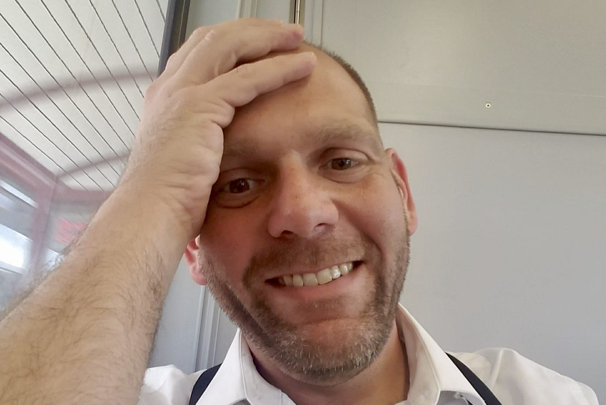 man looking down at camera